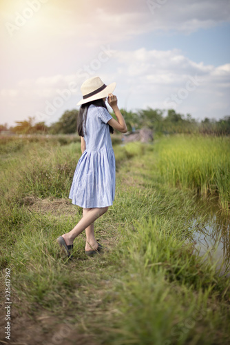 girl with hat in green field © rakT