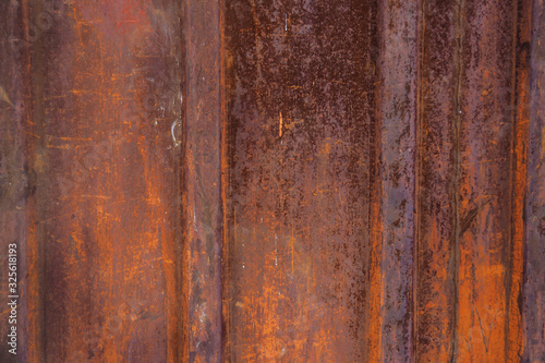 Texture of a rusted metal surface with vertical lines.
