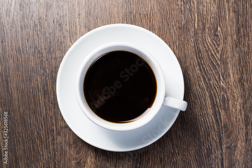 Cup of natural coffee on wooden table