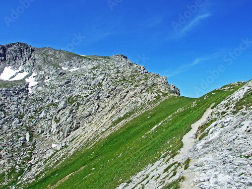 Alpine mountain peak Augstenberg over the Malbuntal alpine valley and in the Liechtenstein Alps mountain range - Malbun, Liechtenstein photo