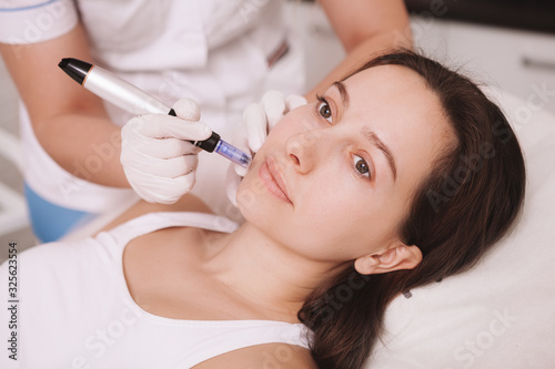 Close up of a young attractive woman getting mesotherapy treatment at beauty salon