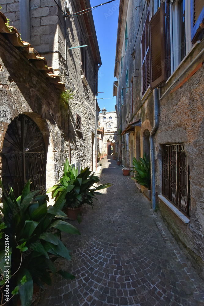 Collepardo, Italy, 02/22/2020. An alley between the old stone houses of a medieval village.