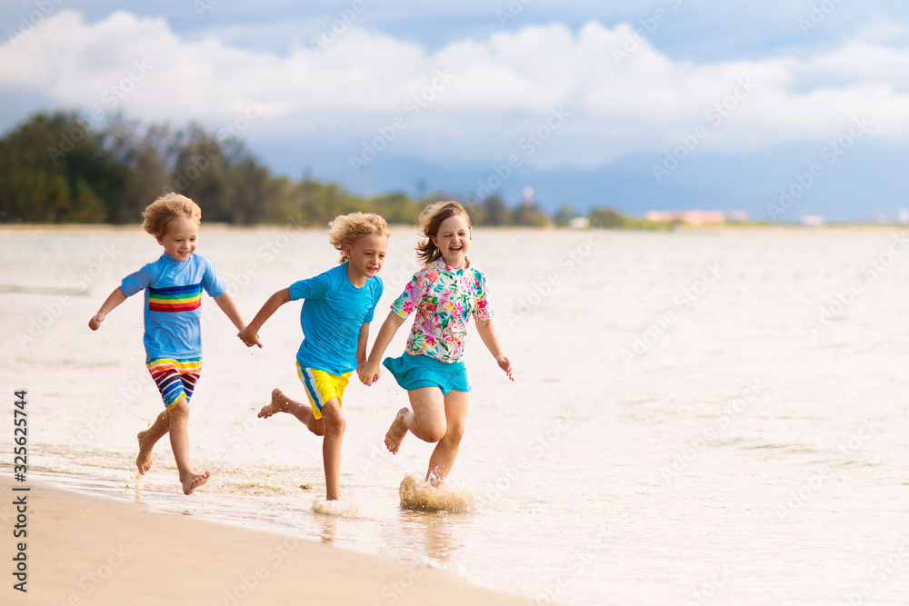 Kids playing on beach. Children play at sea.