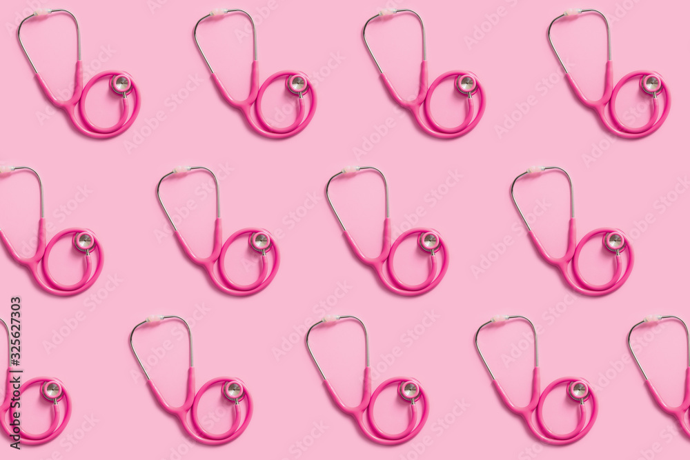 Many stethoscopes on color background
