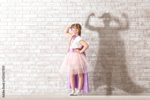 Cute little girl dressed as...