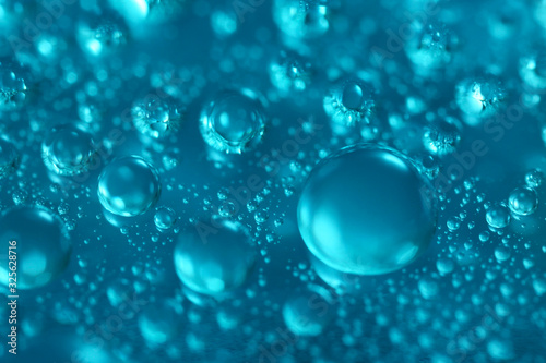Many water drops on blue background  closeup