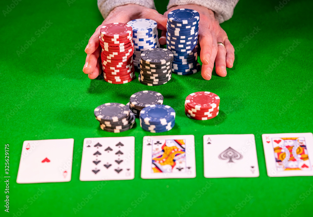 Poker player going all in during a bet on a poker hand Poker player going all in during a bet on a poker hand