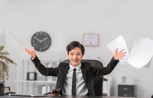 Little lawyer throwing documents in office photo