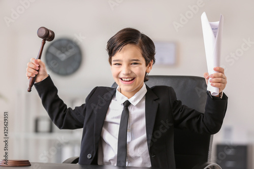 Happy little lawyer with ju...