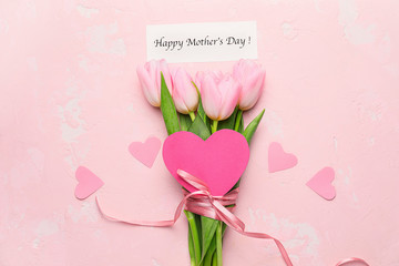 Beautiful flowers and card for Mother's Day on color background