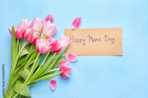 Beautiful flowers and card for Mother's Day on color background