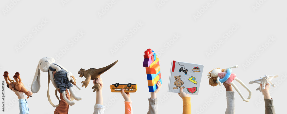 Children holding toys, concept of the childhood - obrazy, fototapety, plakaty 
