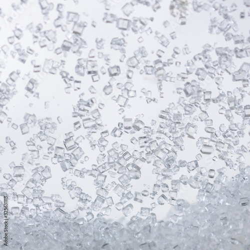 Close up of crystal sugar in Glass bottles on white background.