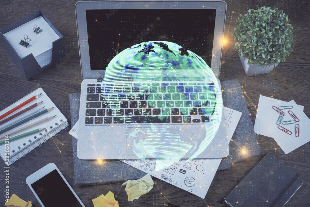 Computer on desktop with social network hologram. Multi exposure. Concept of international people connections. Computer on desktop with social network hologram. Multi exposure. Concept of international people connections.
