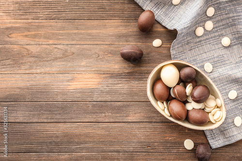 Sweet chocolate Easter eggs on wooden background