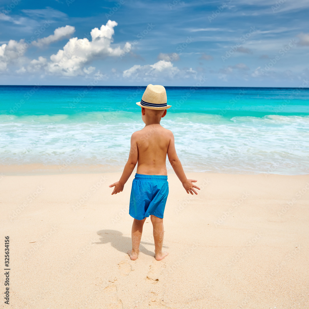 Three year old toddler boy walking on beach Three year old toddler boy walking on beach