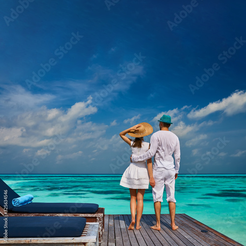 Couple on a beach jetty at Maldives © haveseen