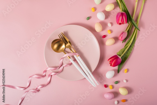 Easter table setting with tulips, eggs, plate, cutlery