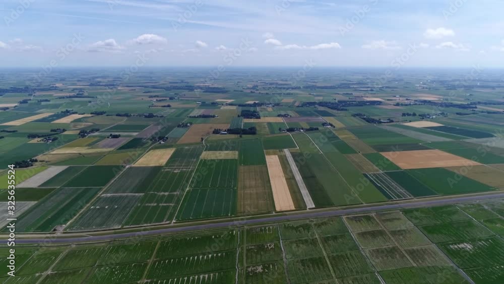 Aerial view of Wadden coastal area panning down first showing the Dutch meadows pastures and later on the coast intertidal zone in the southeastern part of the North Sea the Netherlands 4k quality