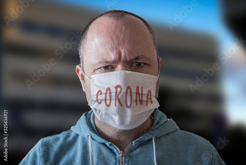 Man wear face mask as with title CORONA photo