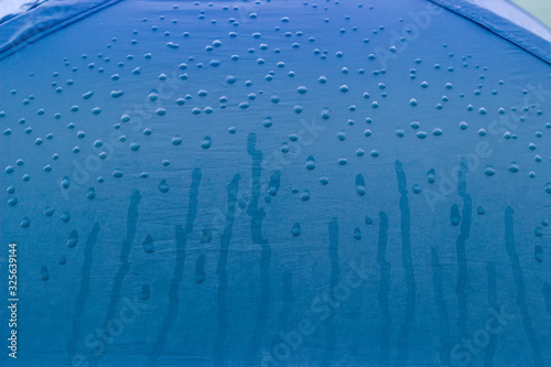 Background of fragment of hiking tent covered with water drops photo