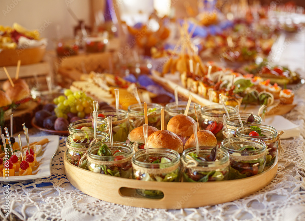 Beautifully decorated catering banquet table with different food snacks.