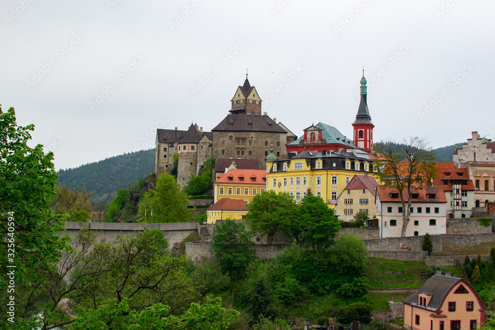 Panorama of the picturesque small village of Loket, with the bridge, the Castle and the Church of St. Wenceslaus at the background (Czech Republic)
