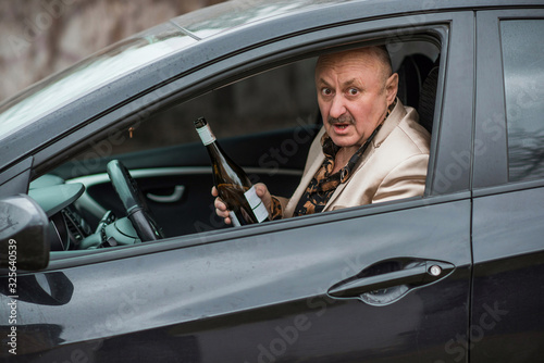 Mature man drink alcohol at car, social problem concept 