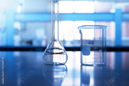 beaker and volumetric flask on chemistry science laboratory table background