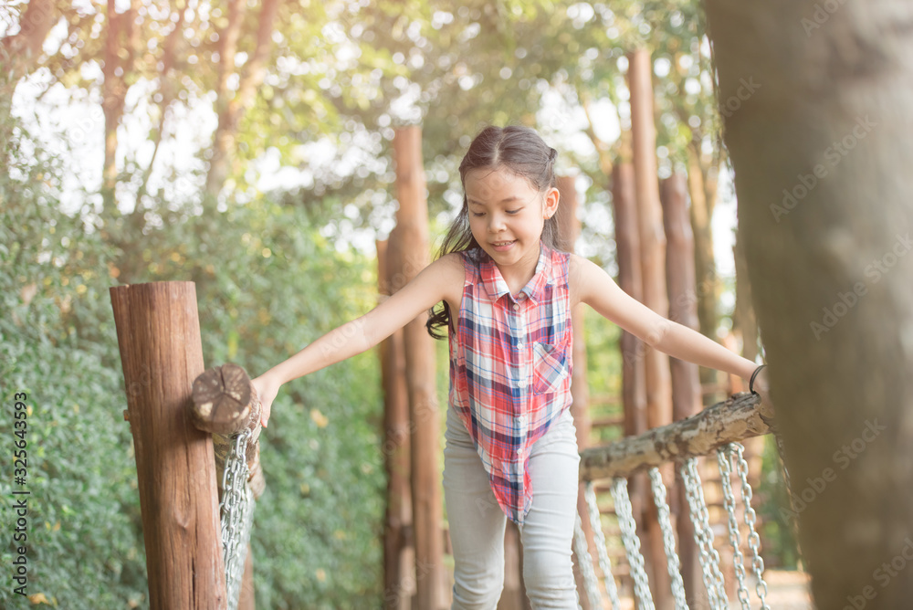 happy little asian girl child having fun to playing in the playground in summer time with smile and laughing healthy, funny smiling face adorable lovely female kid. happy vacation lifestyle concept. happy little asian girl child having fun to playing in the playground in summer time with smile and laughing healthy, funny smiling face adorable lovely female kid. happy vacation lifestyle concept.