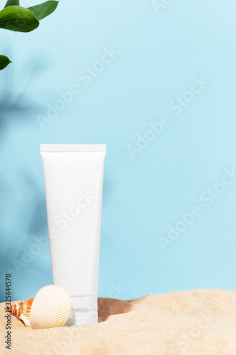 Unbranded white tube. Cosmetics product container with place for text. Blank mockup for facial cream, nourishing, moisturizing lotion, balm on seashore background. Natural, eco-friendly cosmetology