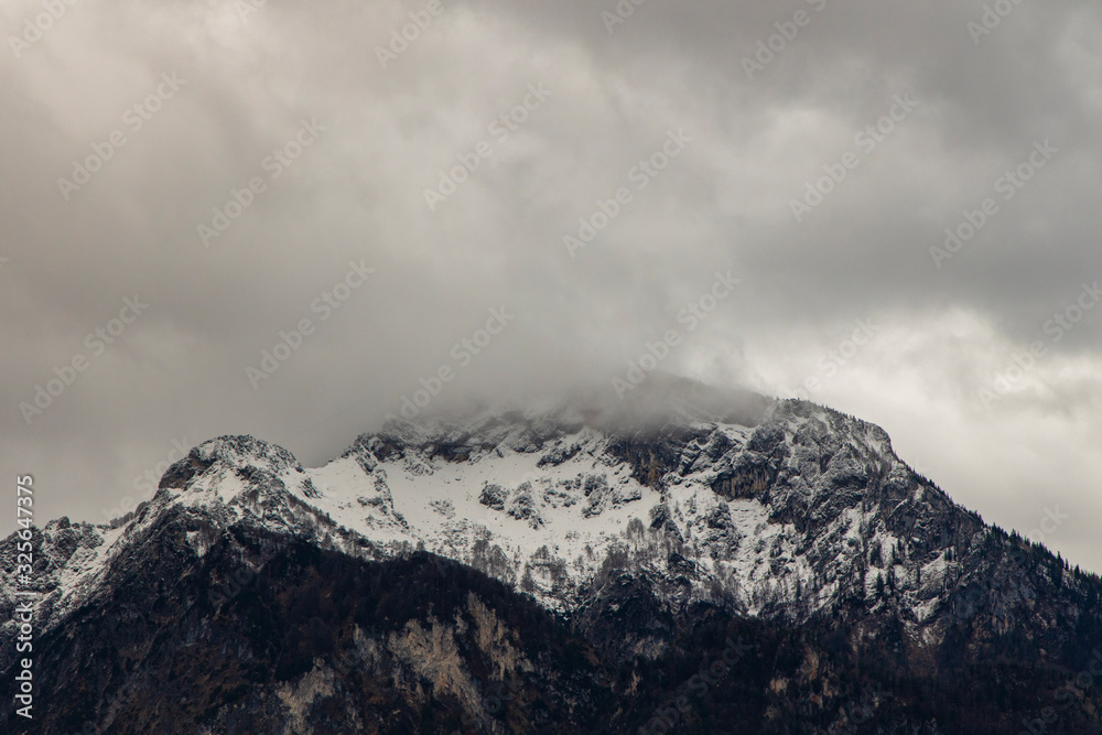misty mountain gorgeous landscape view winter time snow cover and cloudy sky dramatic background space