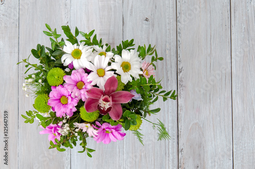 Closeup bouquet on gray wooden table. Greeting card. Festive background. March 8. Valentine's Day.
