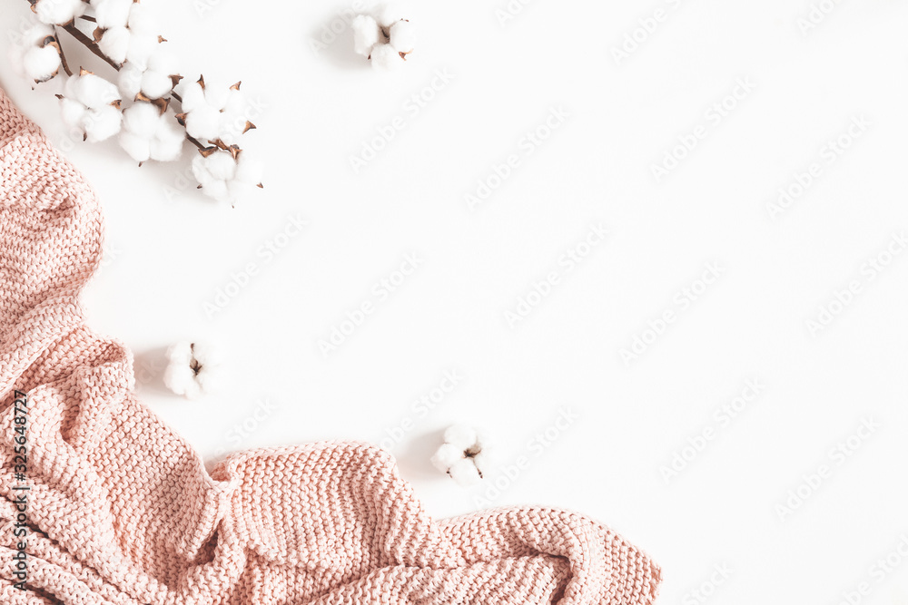 Pink blanket, cotton flowers on white background. Flat lay, top view