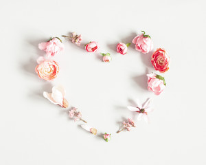 Flowers composition. Heart made of pink flowers on pastel gray background. Valentines day, mothers day, womens day concept. Flat lay, top view