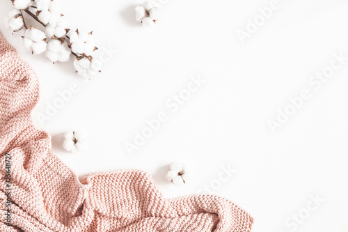 Pink blanket, cotton flowers on white background. Flat lay, top view, copy space