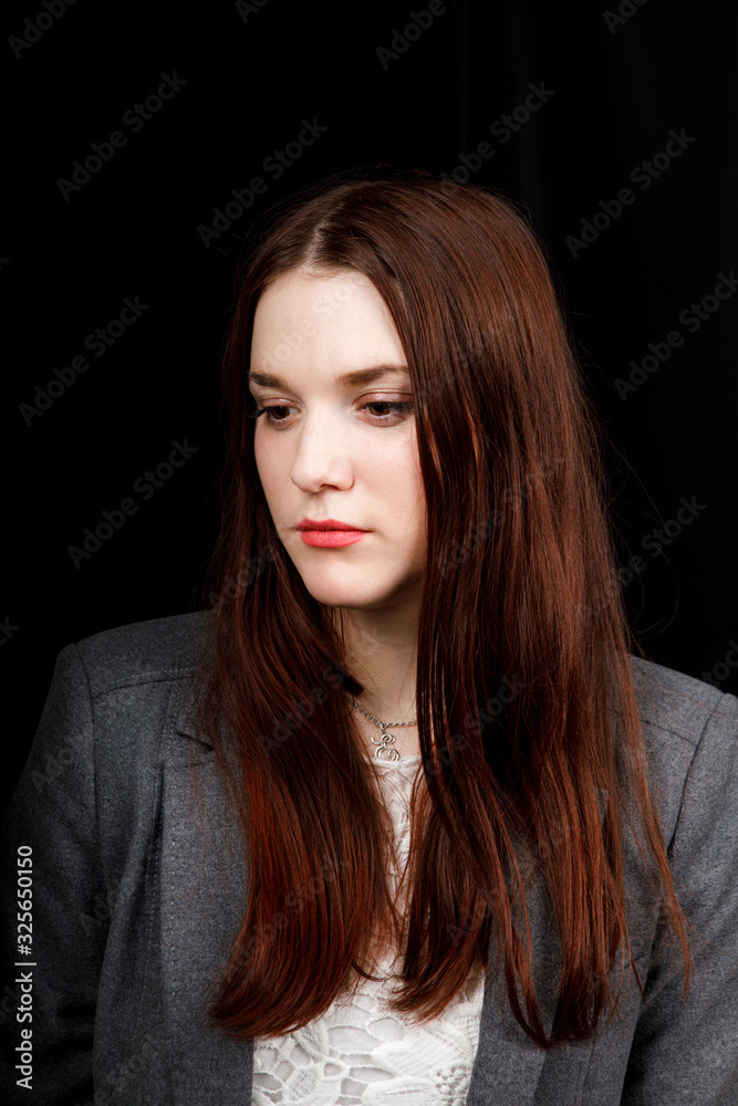 Portrait of successful business woman in
a grey jacket on black background Portrait of successful business woman in
a grey jacket on black background