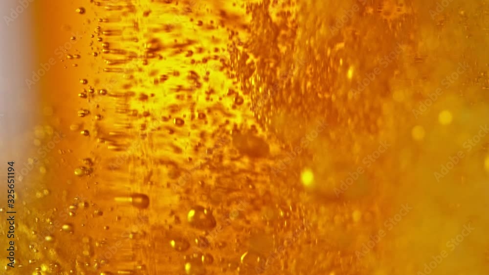 Super Slow Motion Detail Shot of Beer Bubbles in Glass at 1000fps.