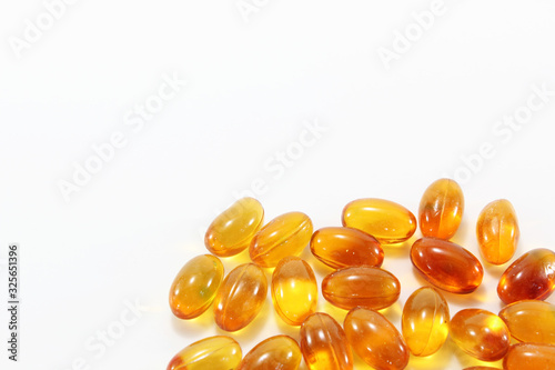 Cod liver oil capsules on white background with free space.