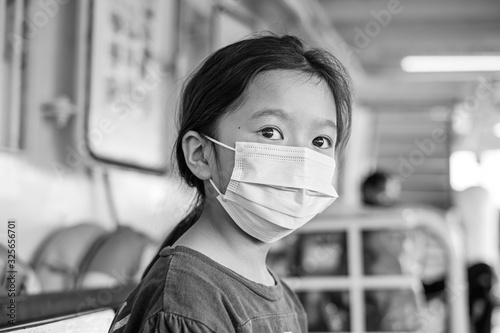 Asian young kid wearing a mask 