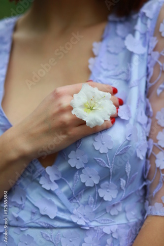 beautiful red-haired girl in arranger where azalea blooms in a colorful flying dress photo