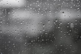 Rain drops on the texture glass at home windows. wallpaper nature beautiful.