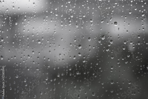 Rain drops on the texture glass at home windows. wallpaper nature beautiful.