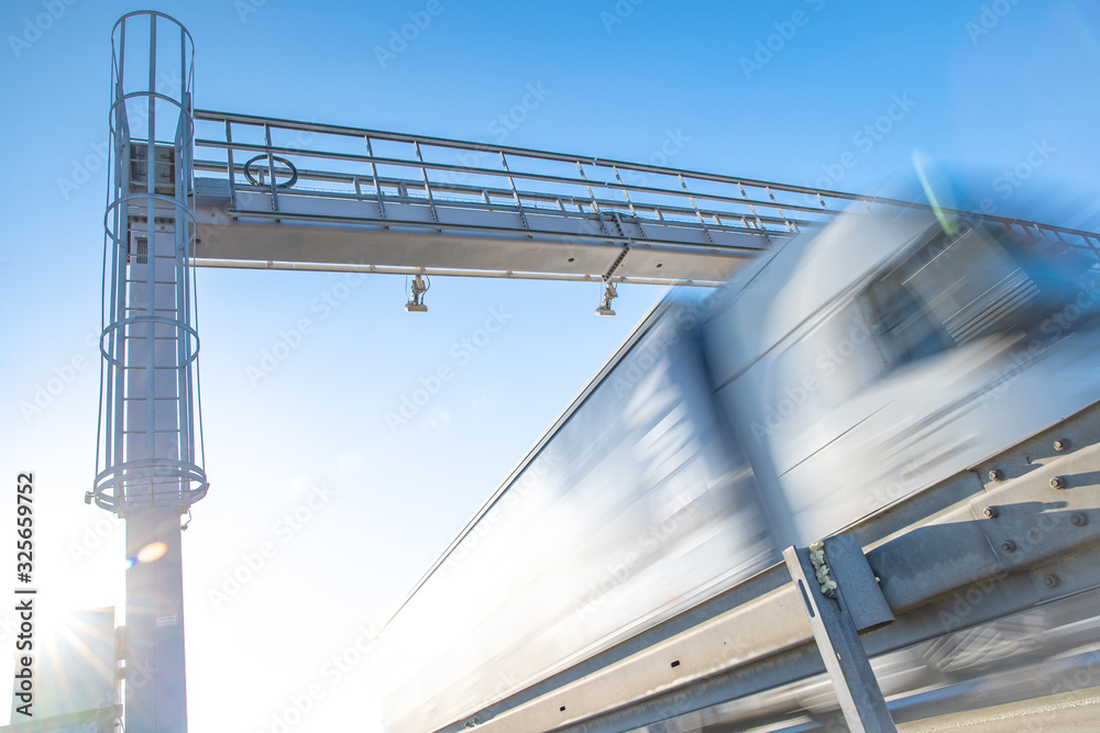 truck passing through a toll gate on a highway toll roads truck passing through a toll gate on a highway toll roads