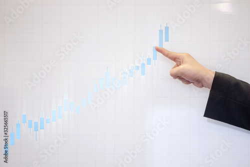 Business hands pointing a presentation board with the financial chart