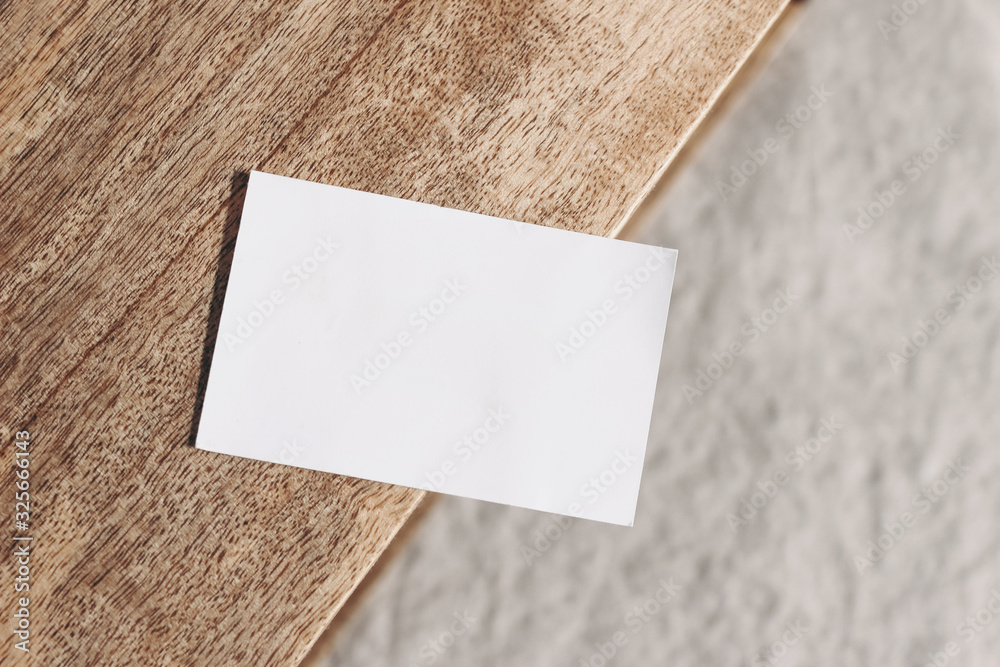 Closeup of blank business card on teak wooden table. Blurred beige linen  background. Empty paper card mockup scene in neutral colors. Branding,  business concept. Sparse composition Top view. Stock Photo | Adobe