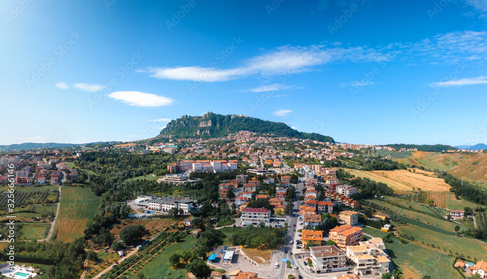 Aerial landscape view from distance on main city rock of San Marino Republic in the background. The concept of the best places for tourism and journey. Down town, Italy