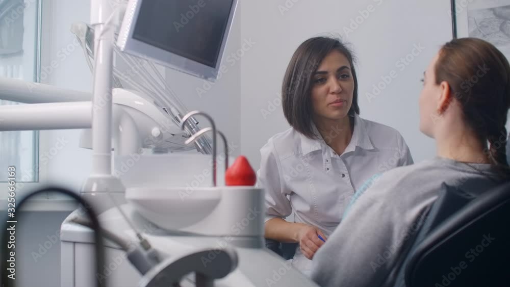 Dentist and patient looking x-ray together. Dentist and patient looking x-ray together.