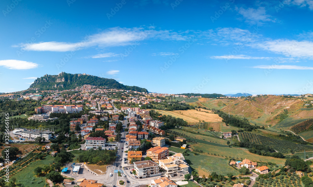 Aerial landscape view from distance on main city rock of San Marino Republic in the background. The concept of the best places for tourism and journey. Down town, Italy
