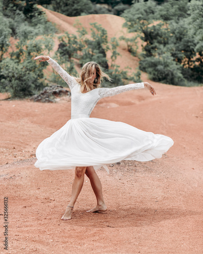 young woman in white dress spinning